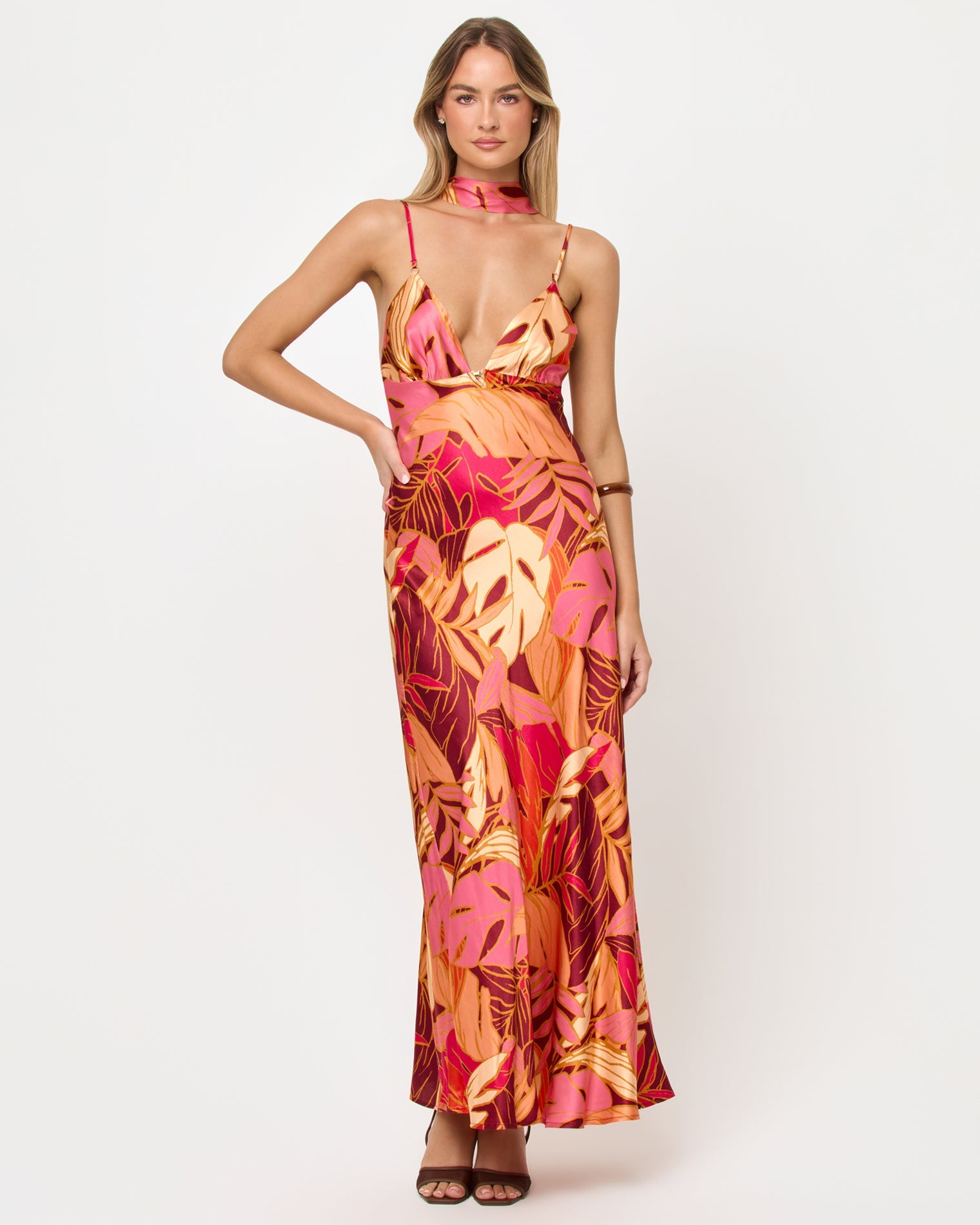 Woman wearing a colorful floral dress on a white background