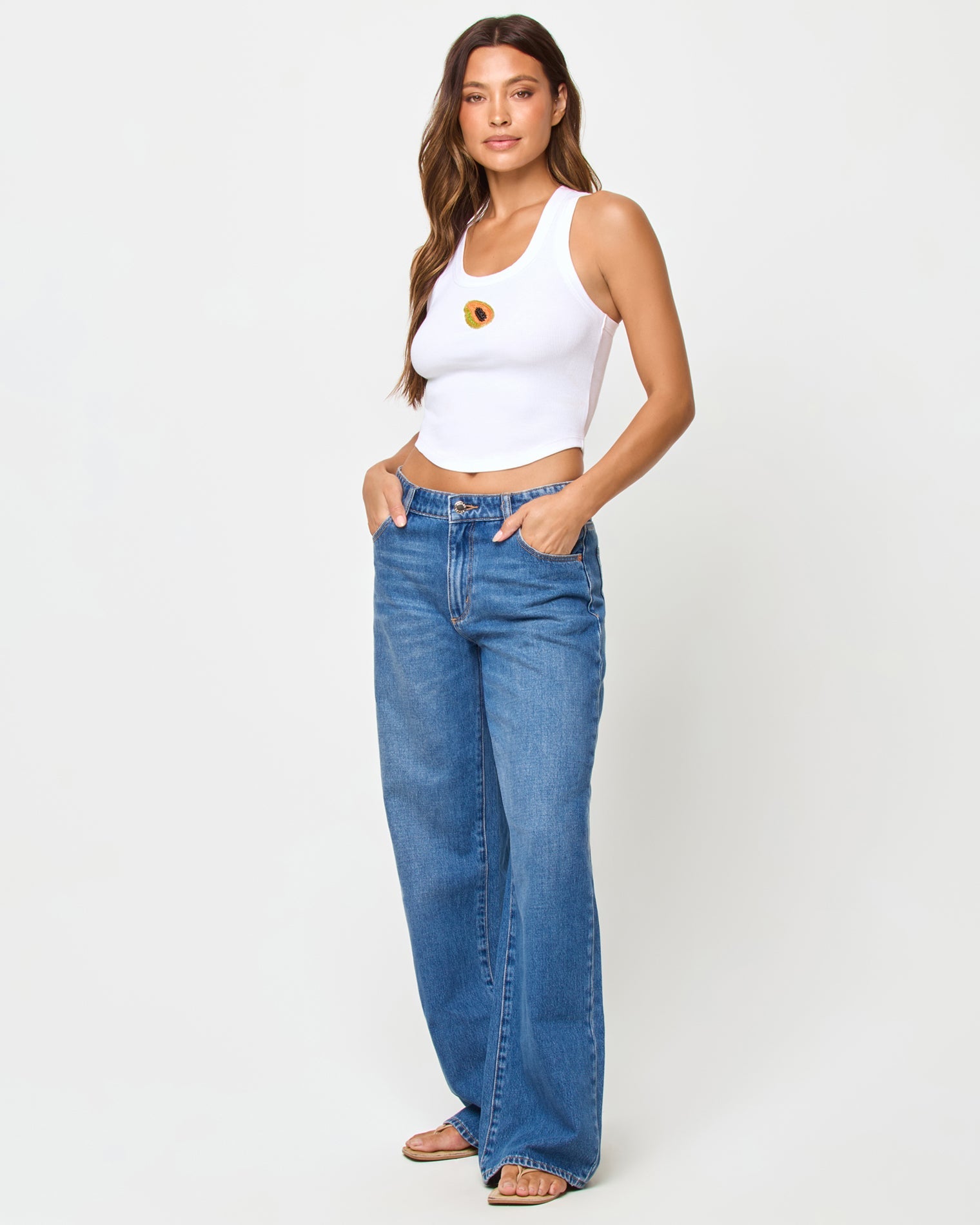 front view of white ribbed tank top with beaded papaya design