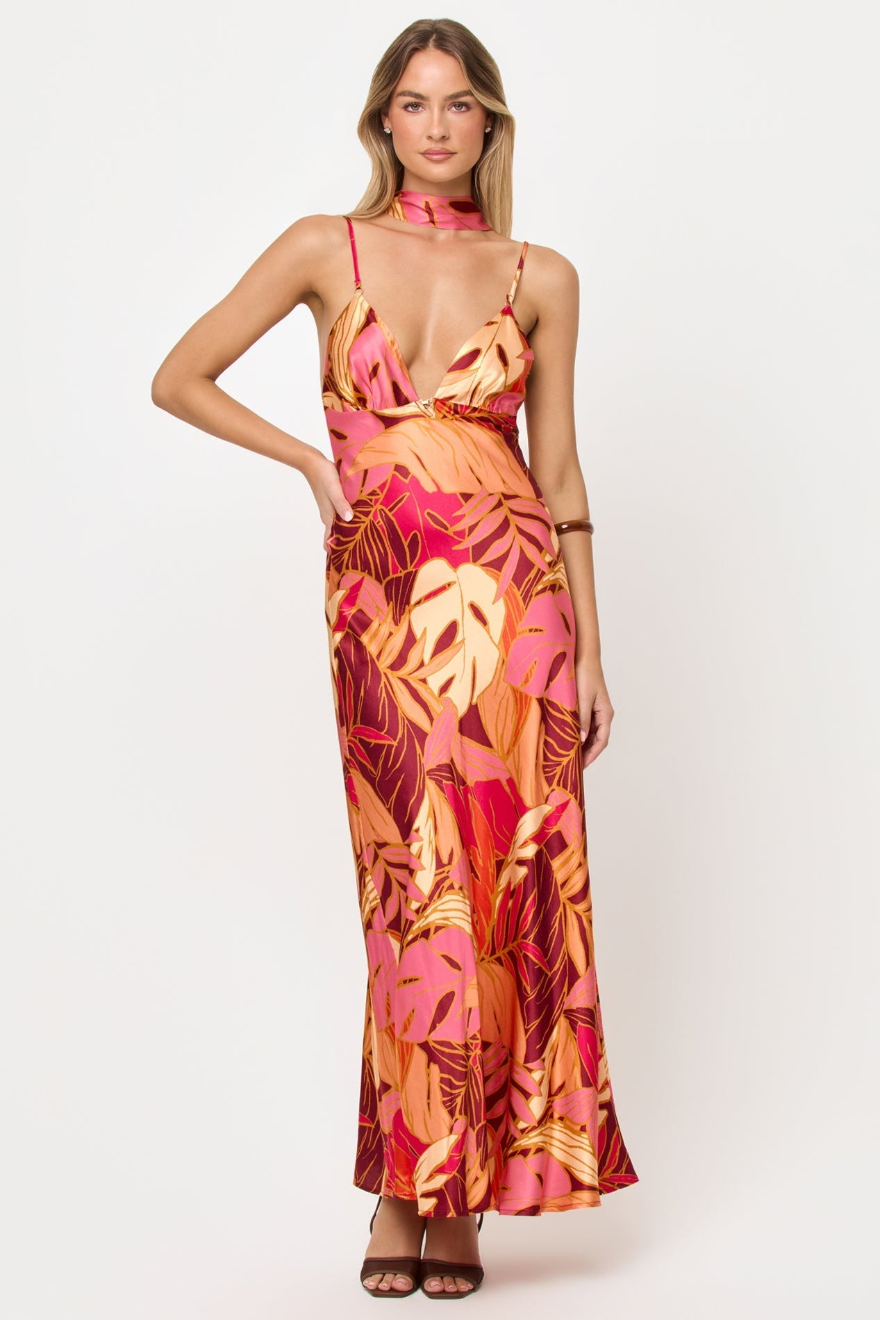 Woman wearing a colorful floral dress on a white background