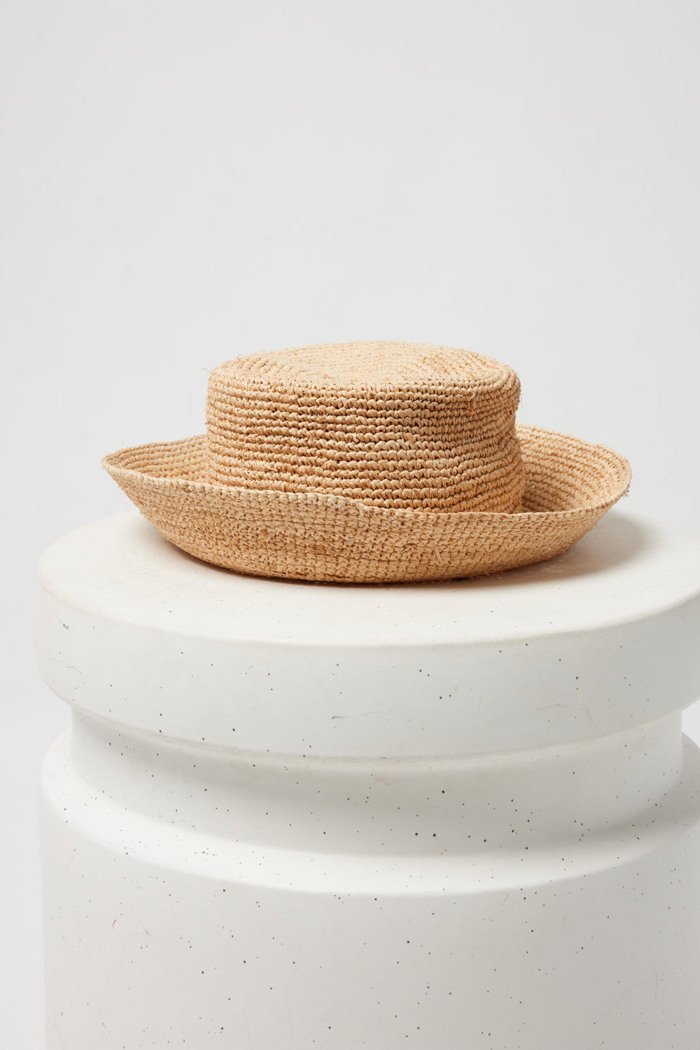 Off-model image of the Isadora Bucket Hat in natural on a white pedestal.