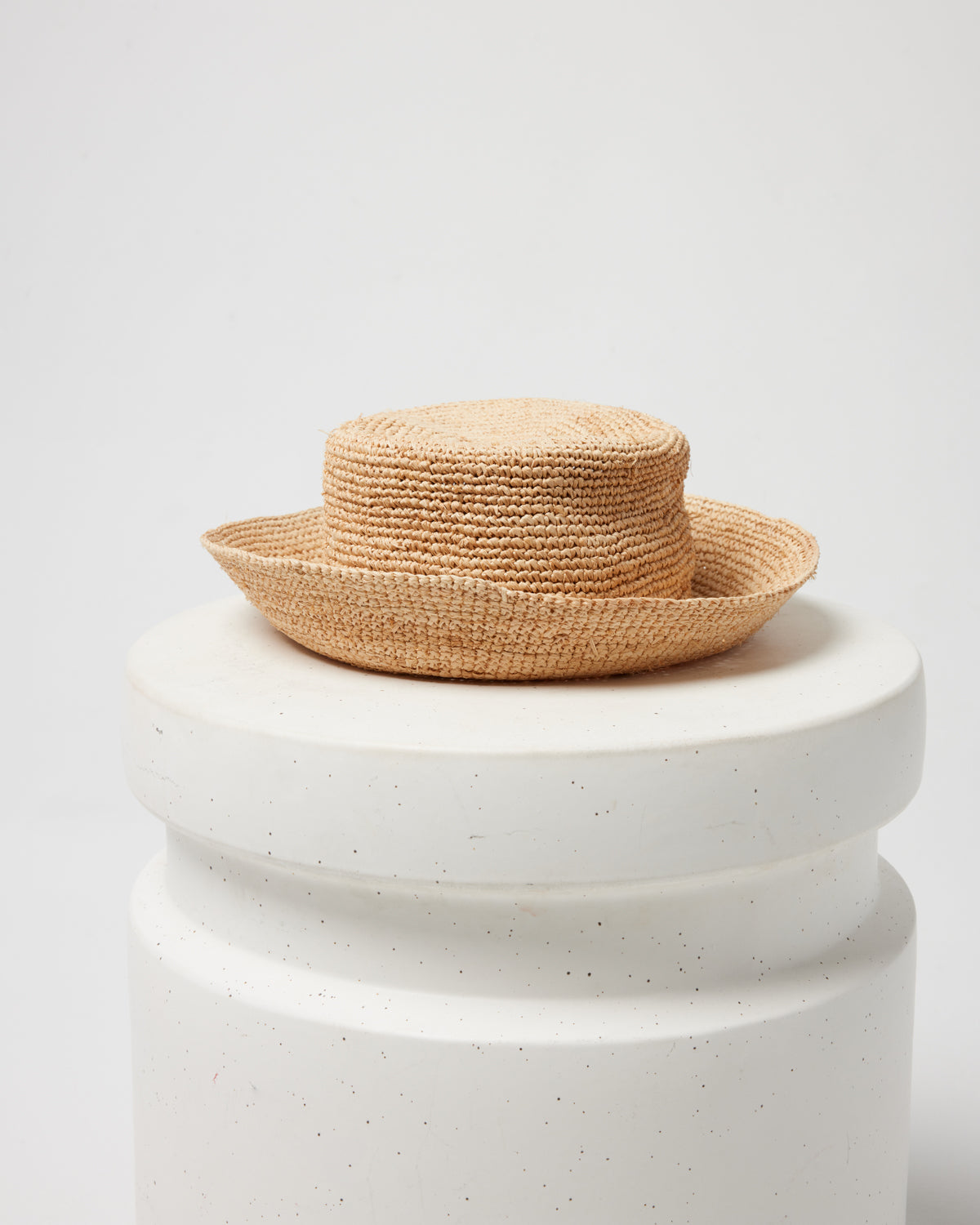 Off-model image of the Isadora Bucket Hat in natural on a white pedestal.